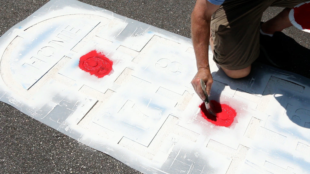 Thickly paint the base coat of paint through the stencil