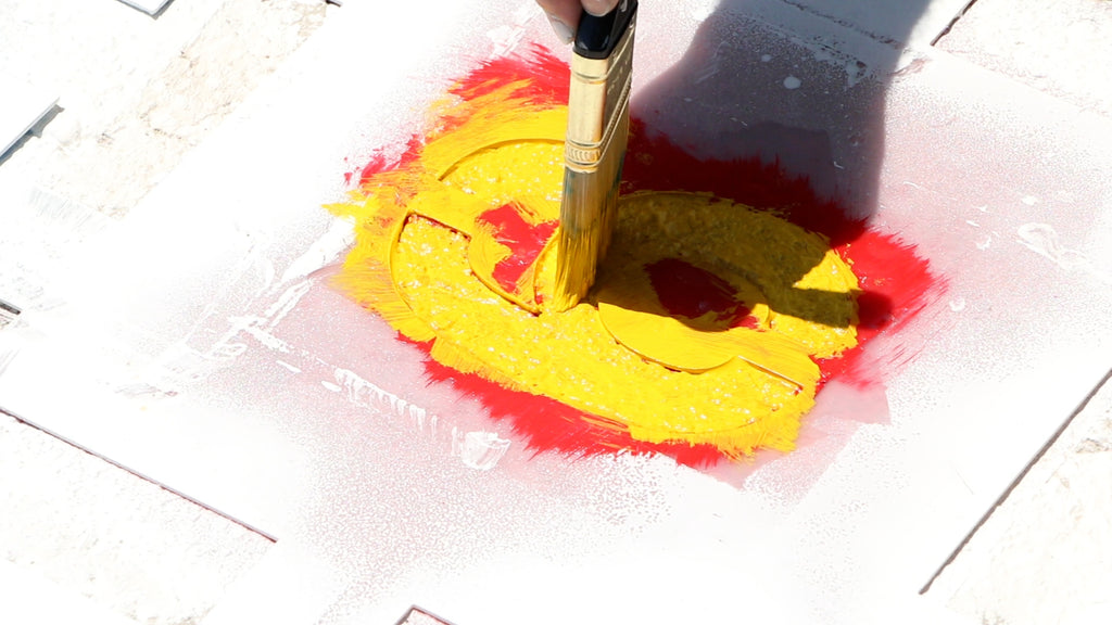 Paint the secondary color of paint through the stencil
