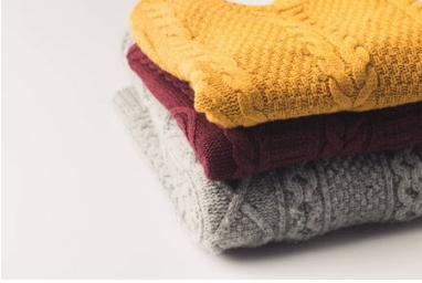 neatly stacked sweaters