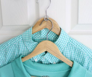 two light blue shirts on hangers