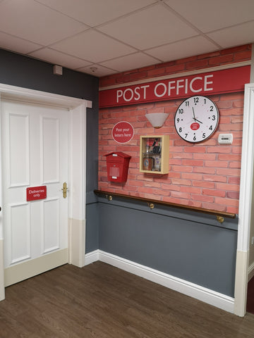 Care home mural of a Post Office with a clock, post box and memory box with stamps and money
