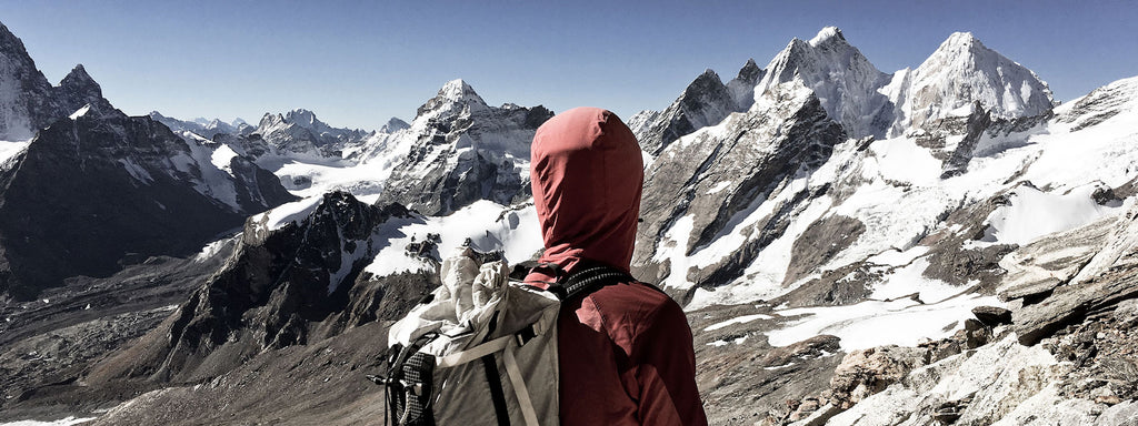 Ultralight backpacker looks over mountains