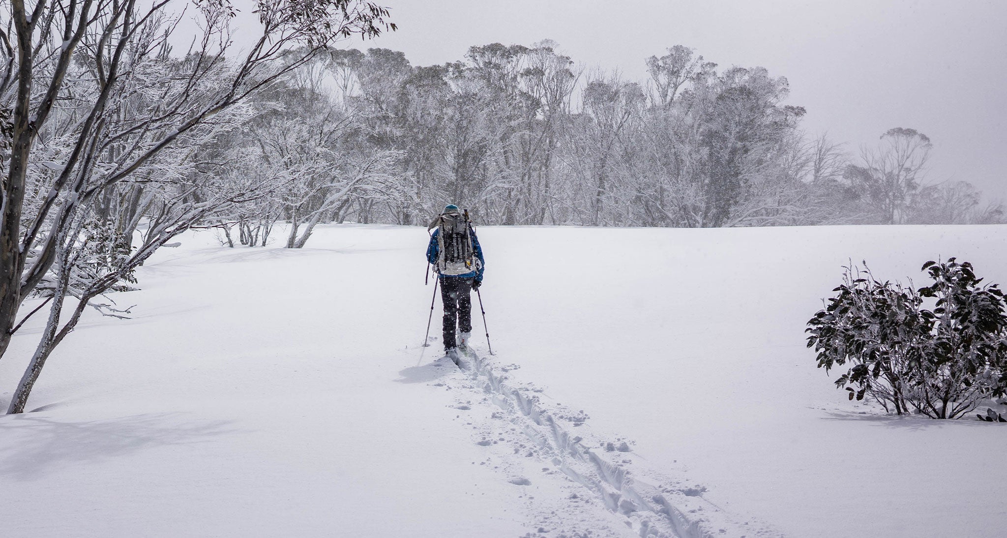 Ultralight backpacker hiking through snow