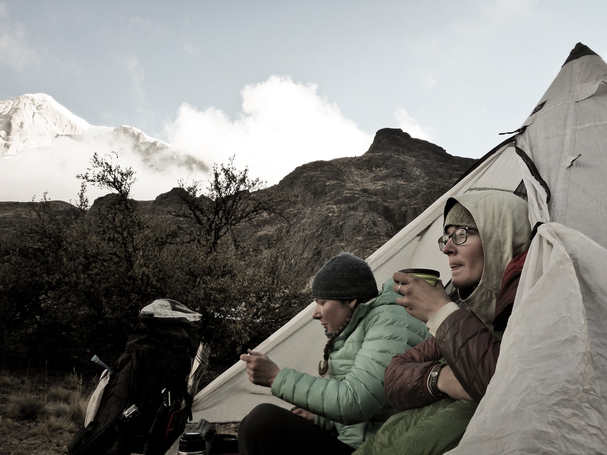 Ultralight backpackers drink coffee in tent