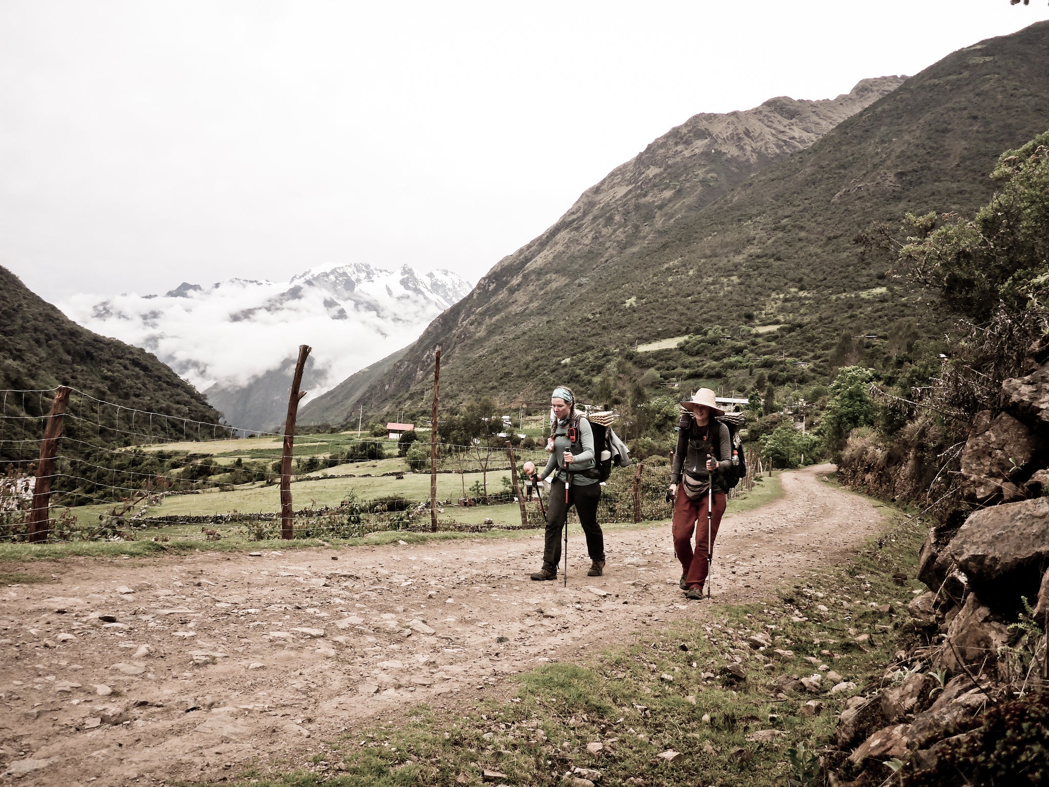 Ultralight backpackers hiking a dirt path in Peru