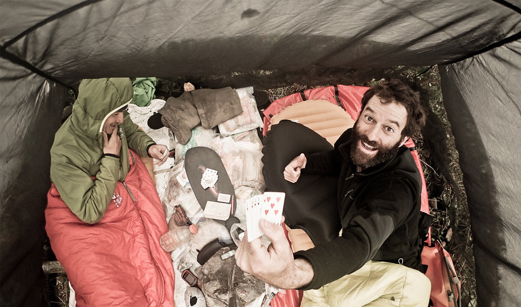 aerial shot of hikers playing cards in their tent