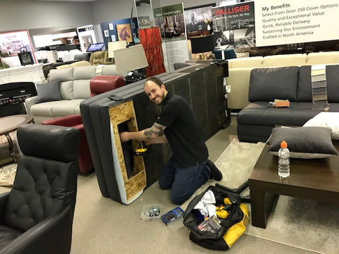 An image of a Hotchkiss furniture expert fixing a couch.