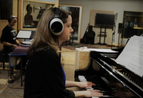 Pianist and composer Kris Davis at her piano with her EL-8 headphones