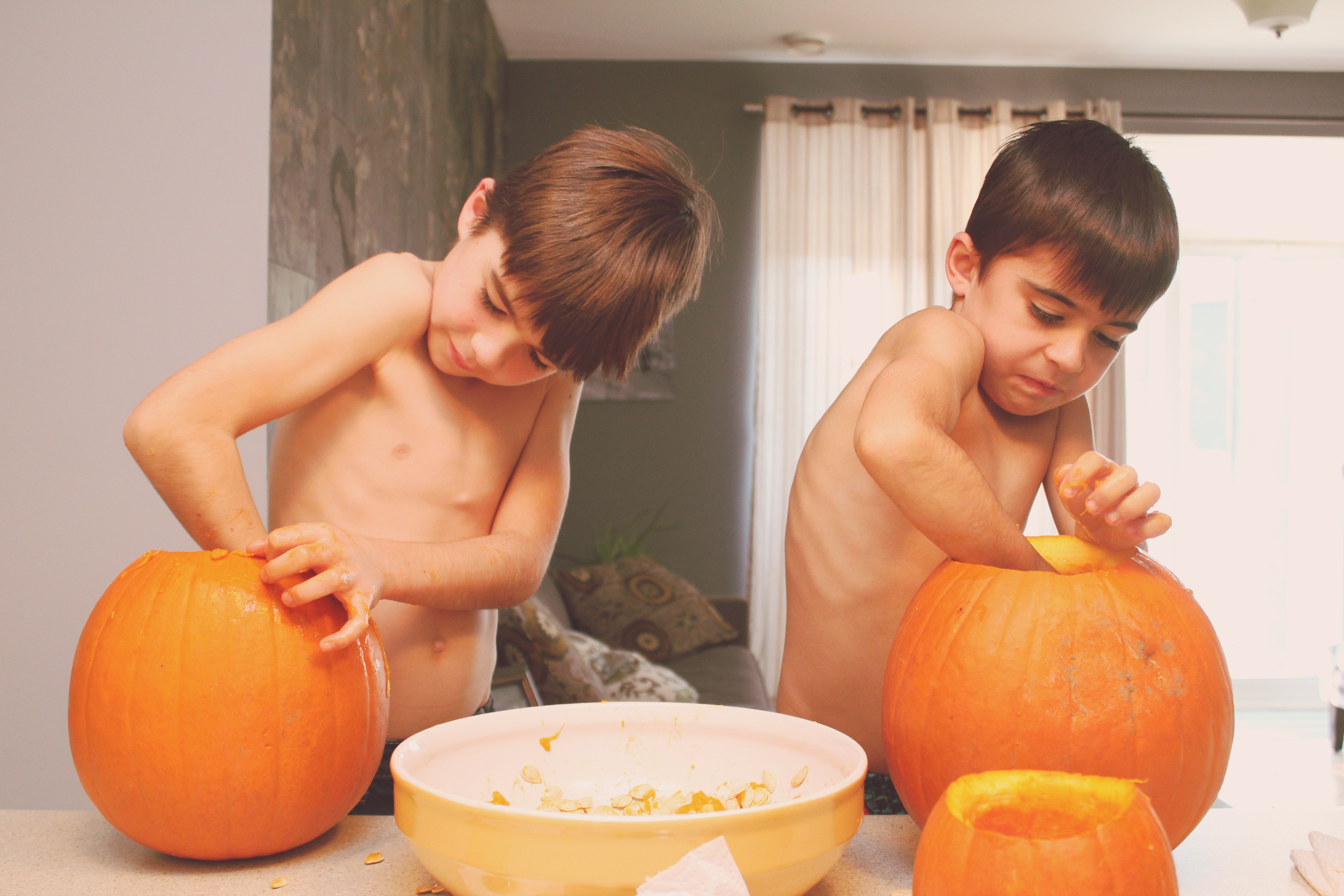 Two Brothers Carving Pumpkins for Halloween