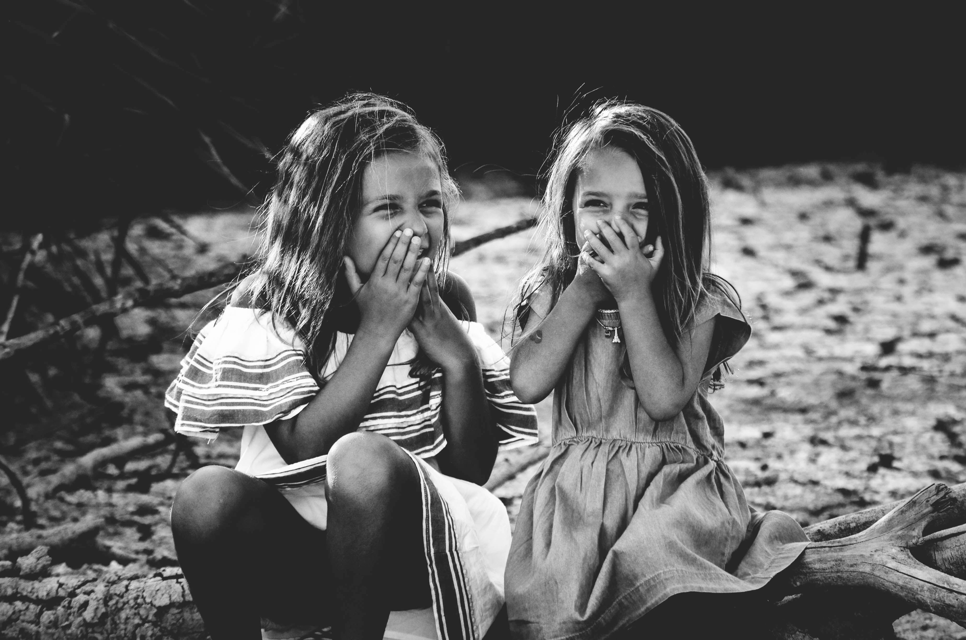 Black & White Image of Two Little Girls Smiling and Laughing - Sibling Photo Ideas