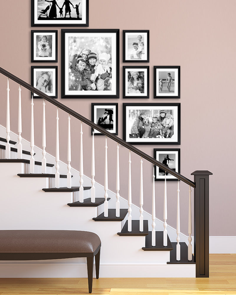 A Gallery Wall of Family Photos Printed in Black & White in Stairway