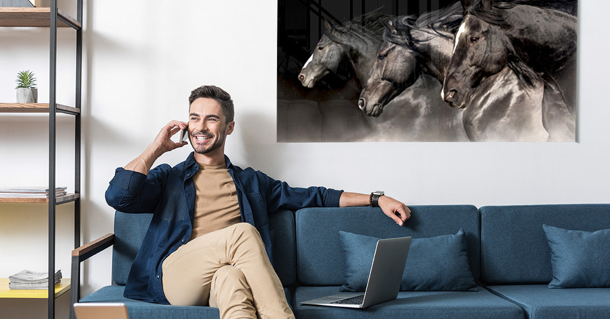 Man Sitting on Couch with a Posterjack Acrylic Print Displayed Behind Him