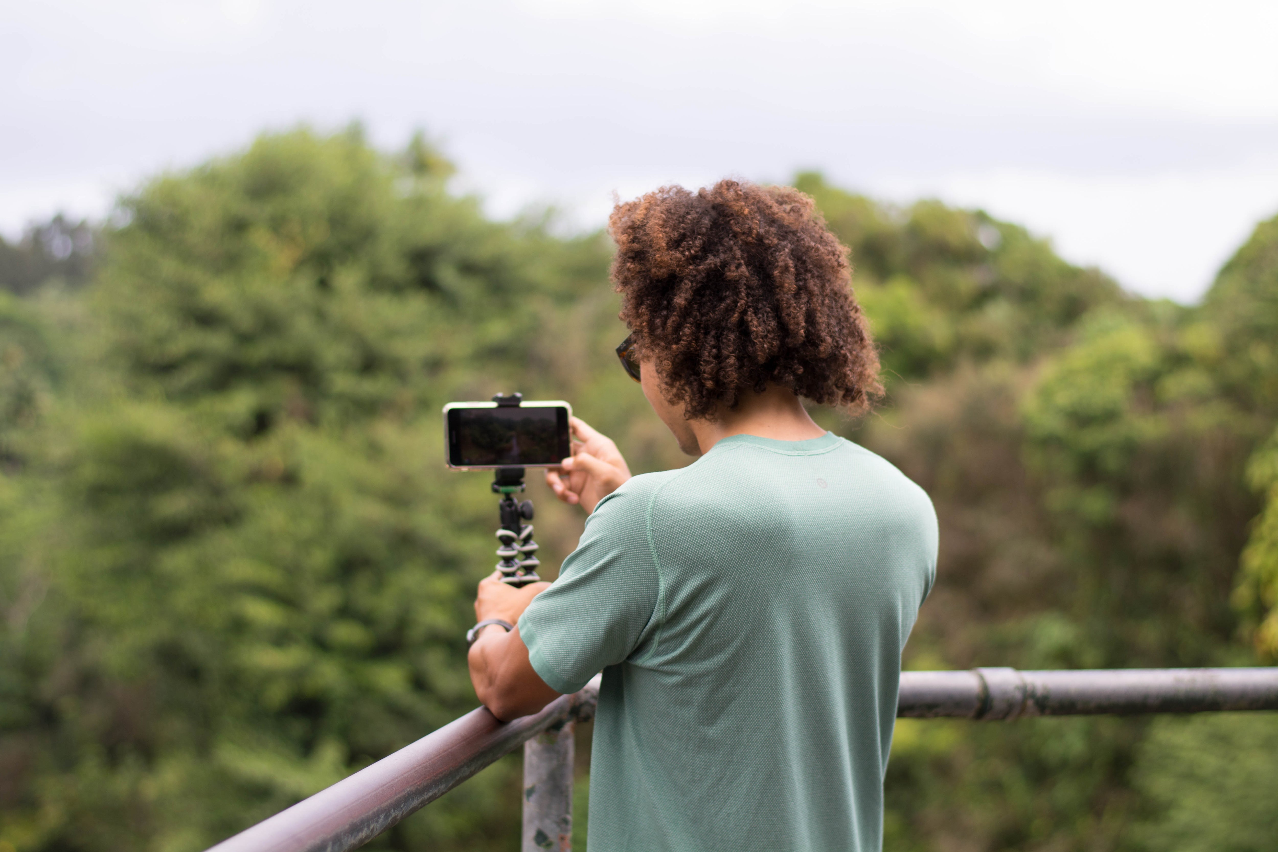 Person Stabilizing Smartphone Camera with Tripod