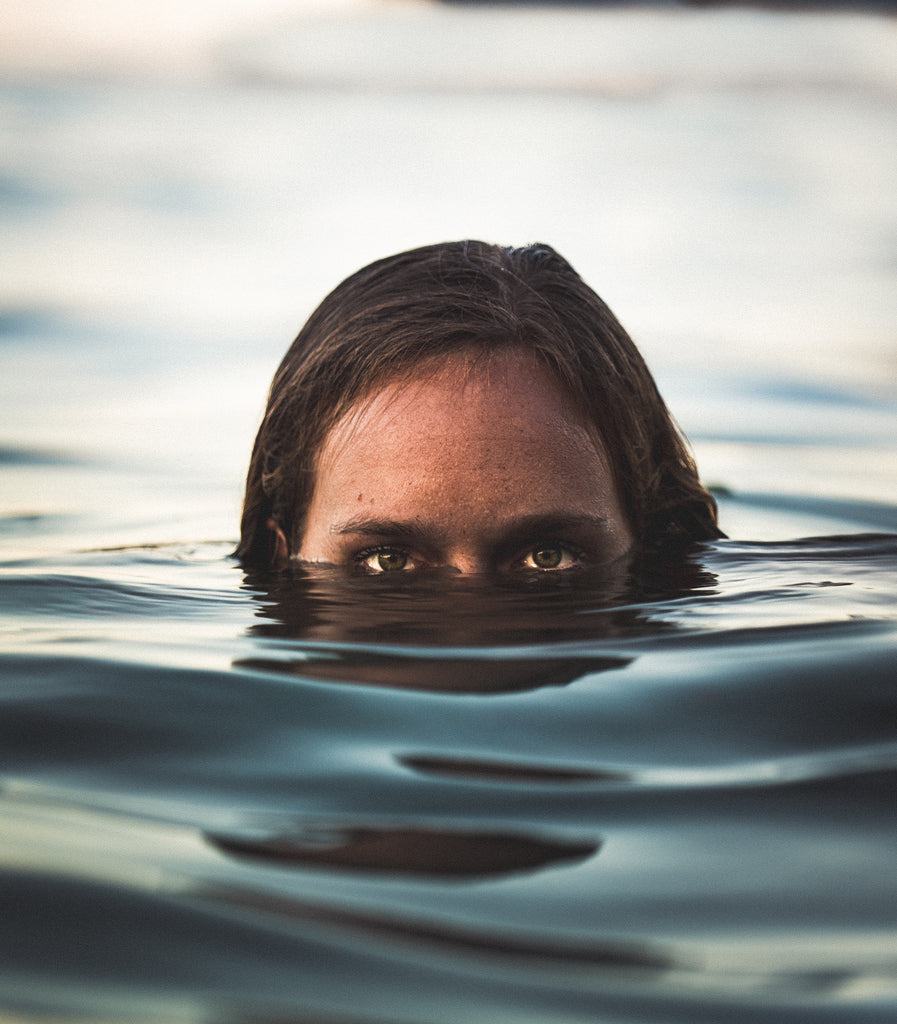 Head sticking out of water with only eyes and top of head showing