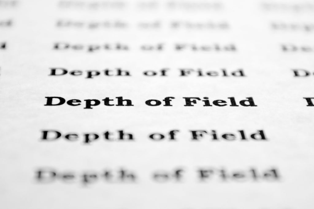 "Depth of field" typed on paper in and out of focus