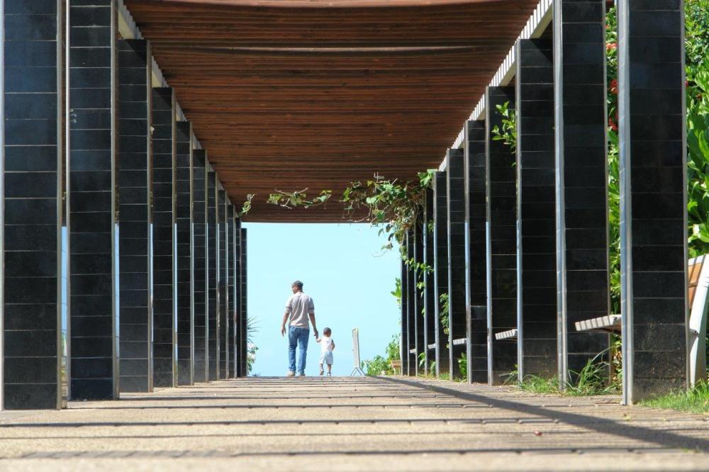 Man and child walking under a bridge as an example of compositional framing