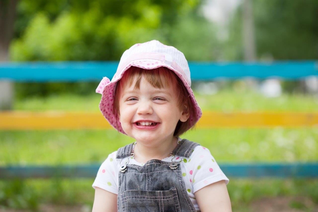 Portrait of a little girl with a big smile - understanding your digital camera's scene modes