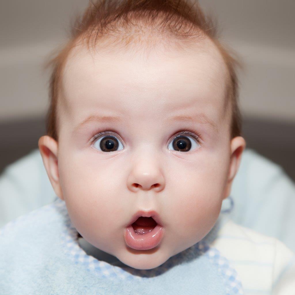 Portrait of a baby with a surprised look on his face