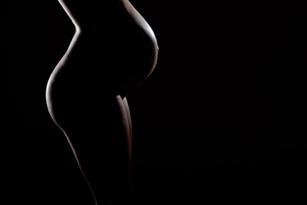 Pregnant woman's silhouette illustrating the use of curved leading lines in photography