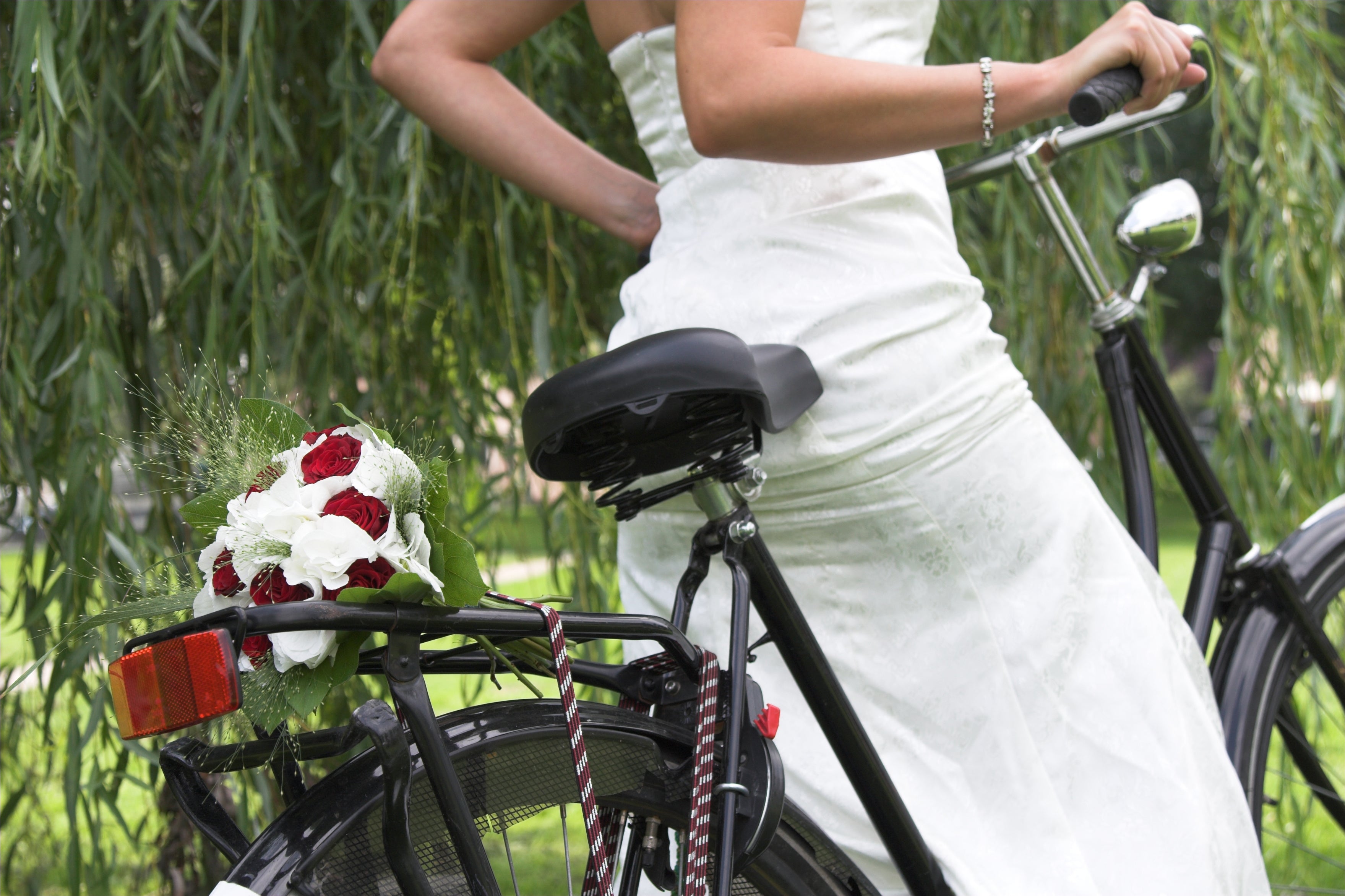 Wedding flower bouquet and bride on a bicycle