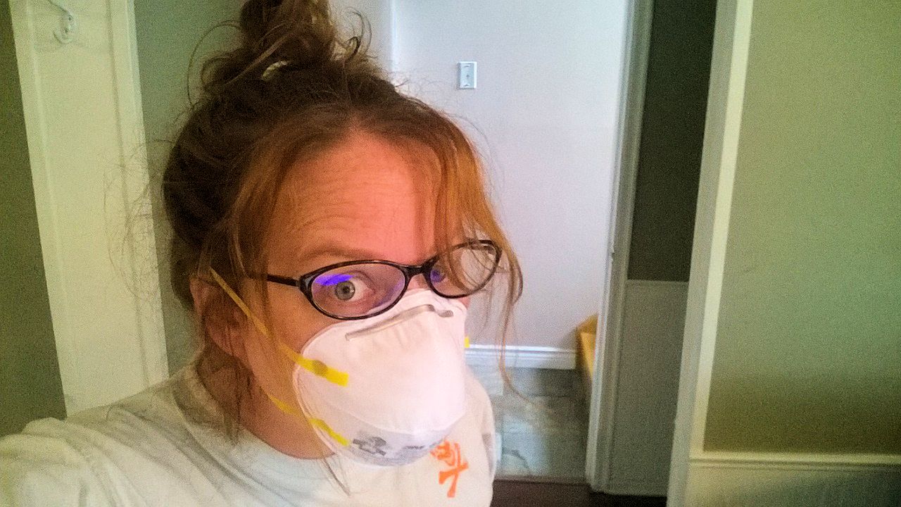 Room makeover selfie with hair up and gloves and mask on
