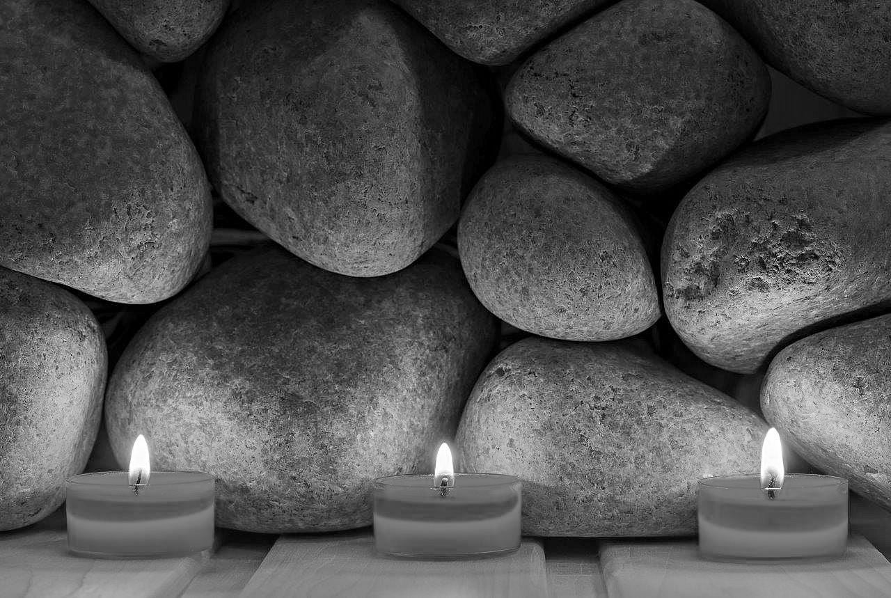 Burning candles in black and white, illustrating how to take photos in low-light situations