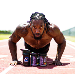Reggie does pushups on a running track with Boneafide Nutrition products in front of him