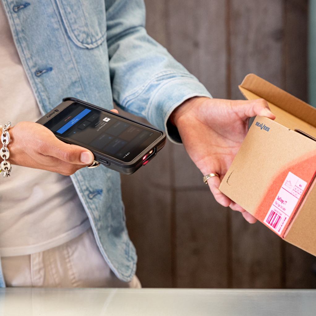 A sales associate scans a barcode using POS Go.