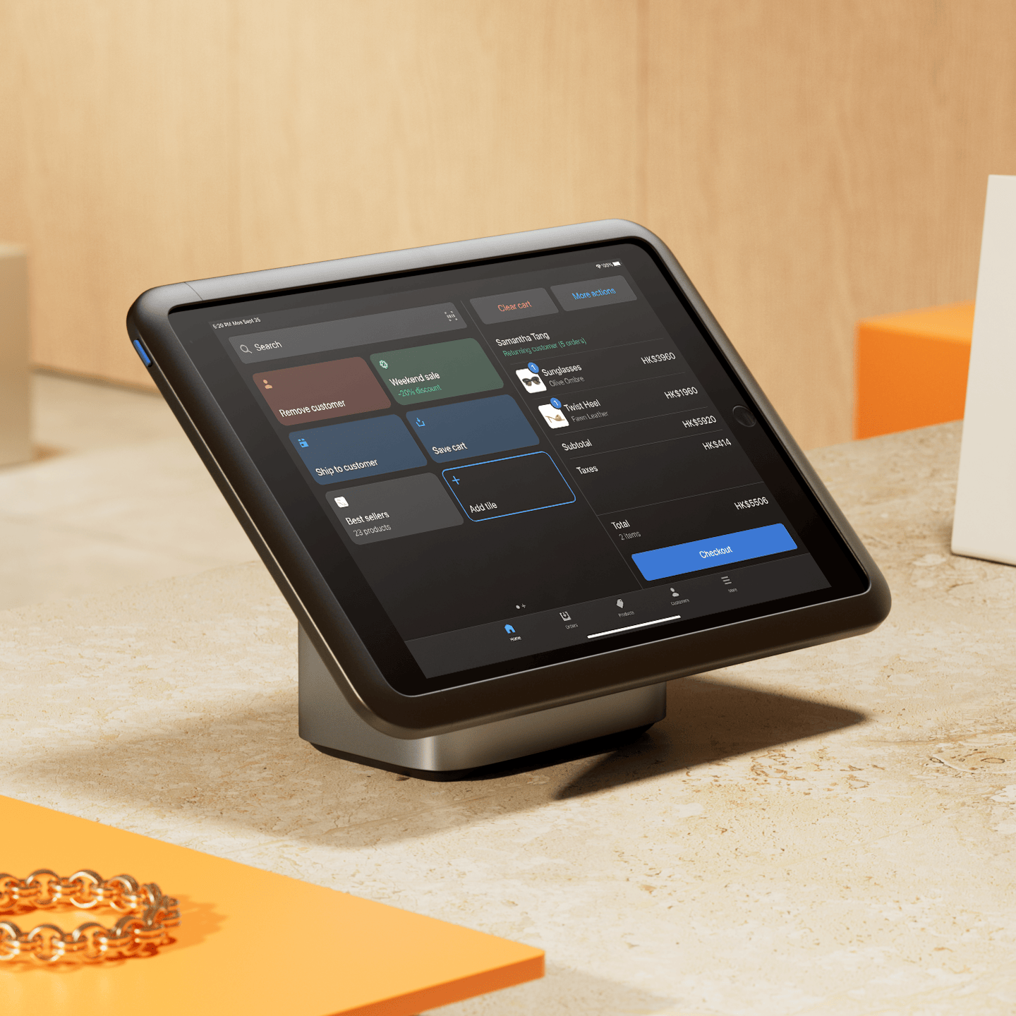 A POS tablet sits on a retail counter running Shopify POS on its display.