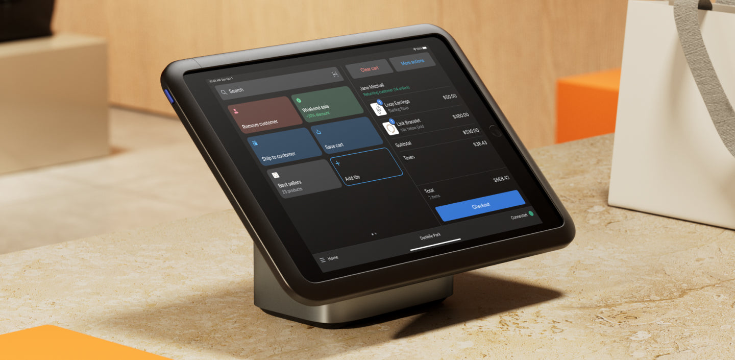 A Shopify POS tablet appears on top of an image of a retail counter.