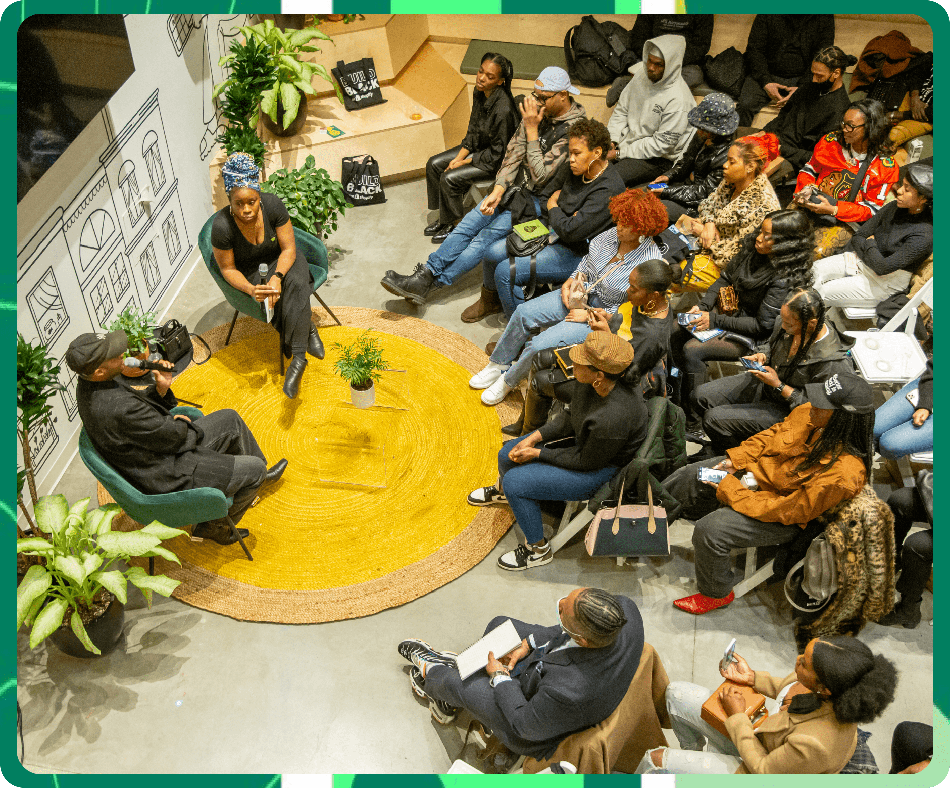 A wide-view from above of an on-stage conversation with a Black entrepreneur providing insight only available to the Build Black Community.