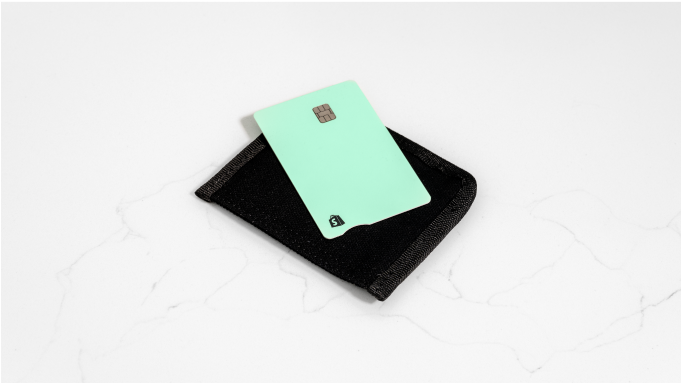 Shopify Credit business card on top of a black leather wallet