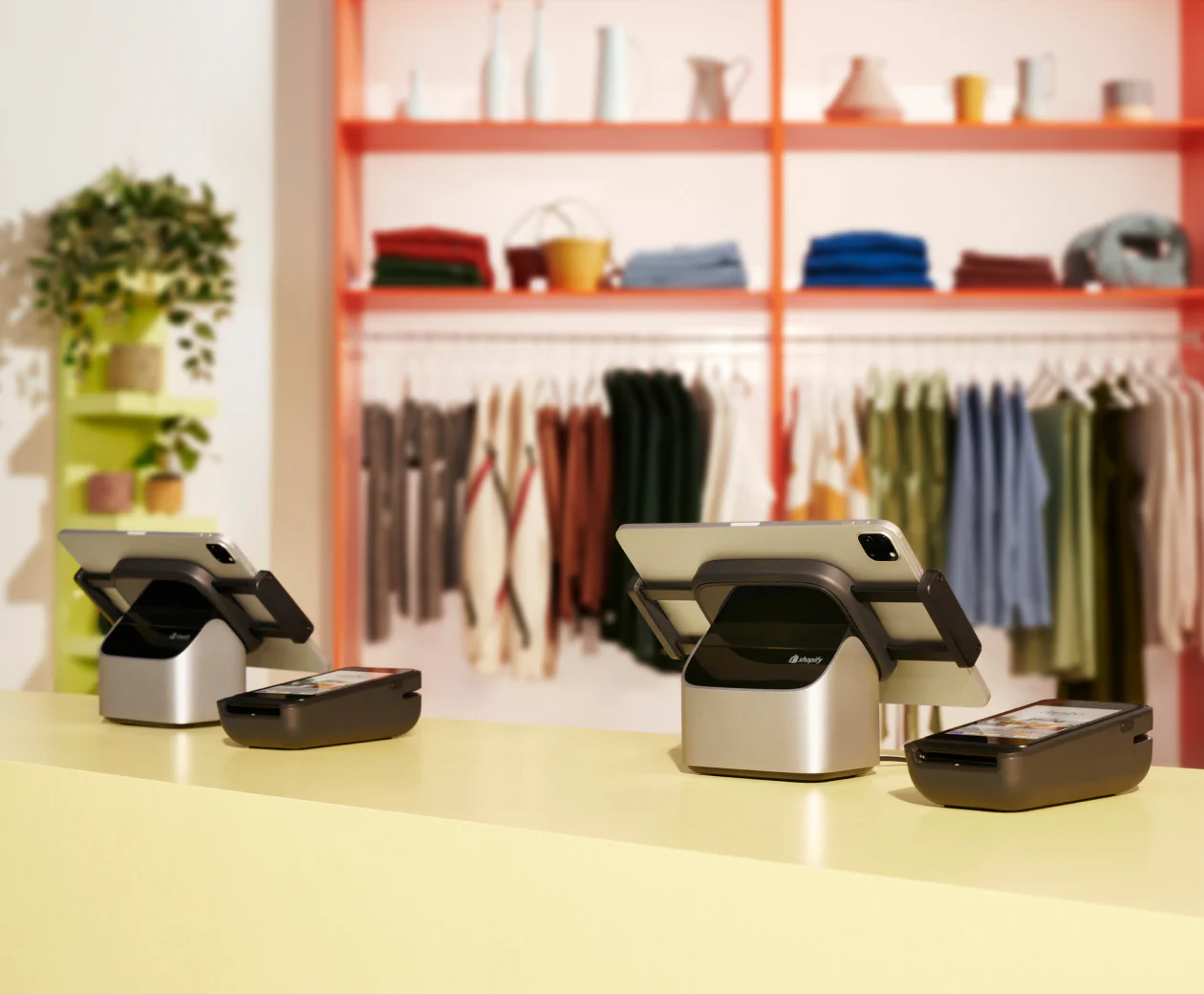 Two Shopify POS countertop kits with POS Terminal and tablet stand on a retail counter.