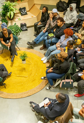 An ariel photo of an on-stage conversation with Brandon Blackwood, a Black entrepreneur providing insight to an audience of Build Black Community members.