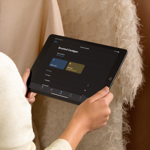 Image of a woman on a tablet looking at POS software