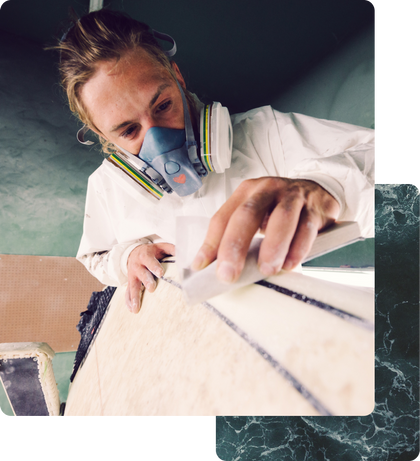 A white male Shopify merchant sanding wood and building furniture in his studio