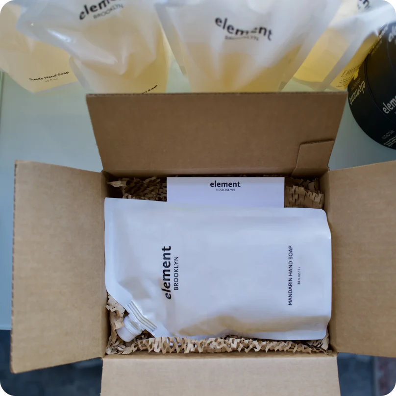 A soap refill from Element Brooklyn inside an open box with additional refill packages nearby for shipping