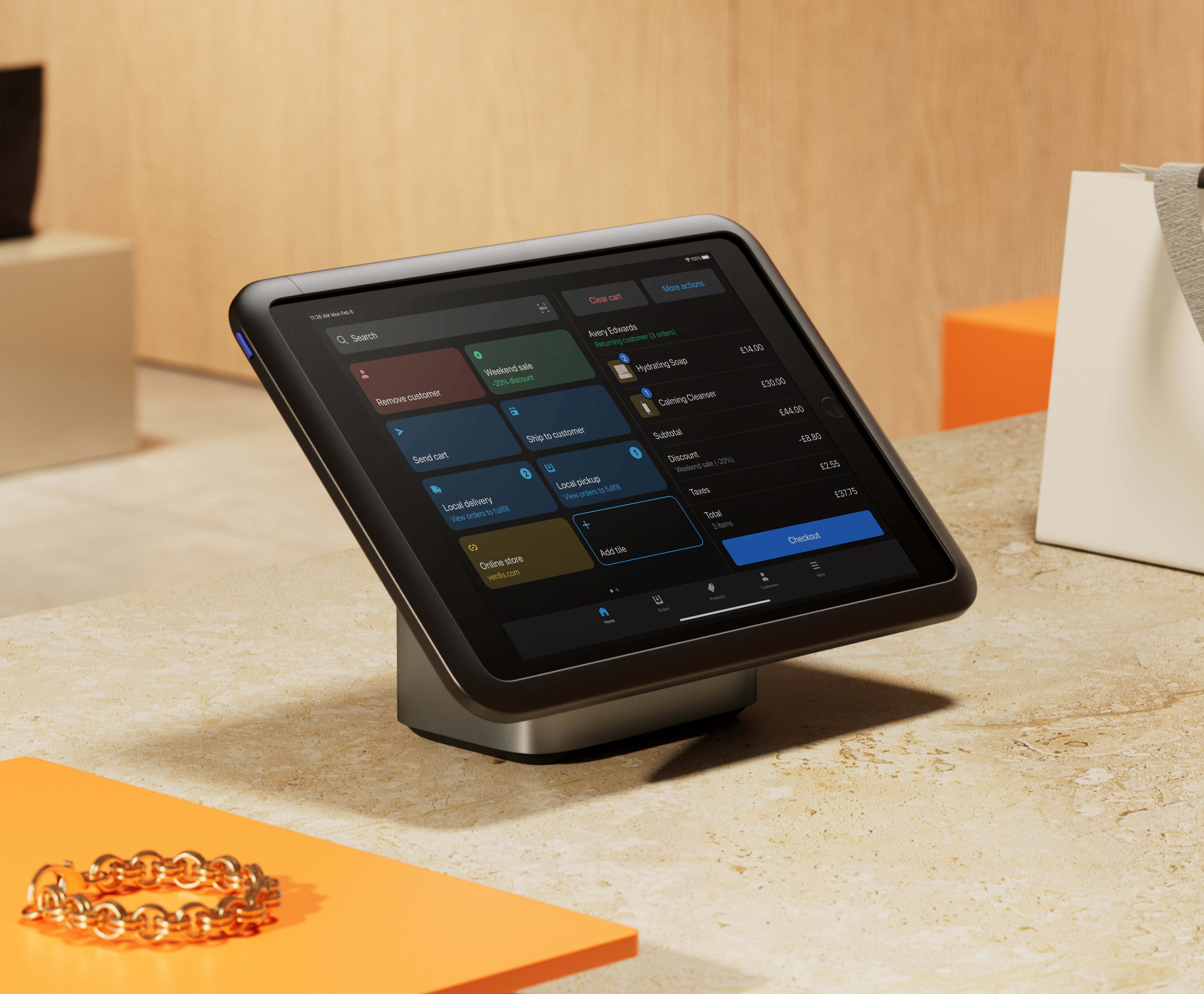 Tablet running Shopify Point of Sale on a sales counter.