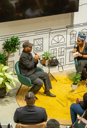 A close-up photo of an on-stage conversation with Brandon Blackwood, a successful Black entrepreneur sharing excerpts from his entrepreneurial journey. 