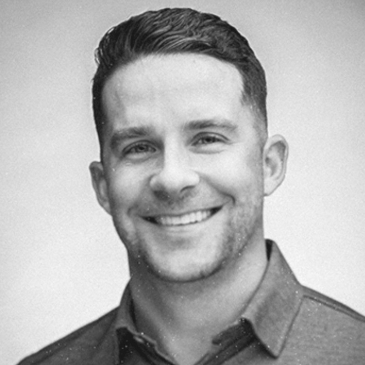 Black and white photo of man smiling into camera