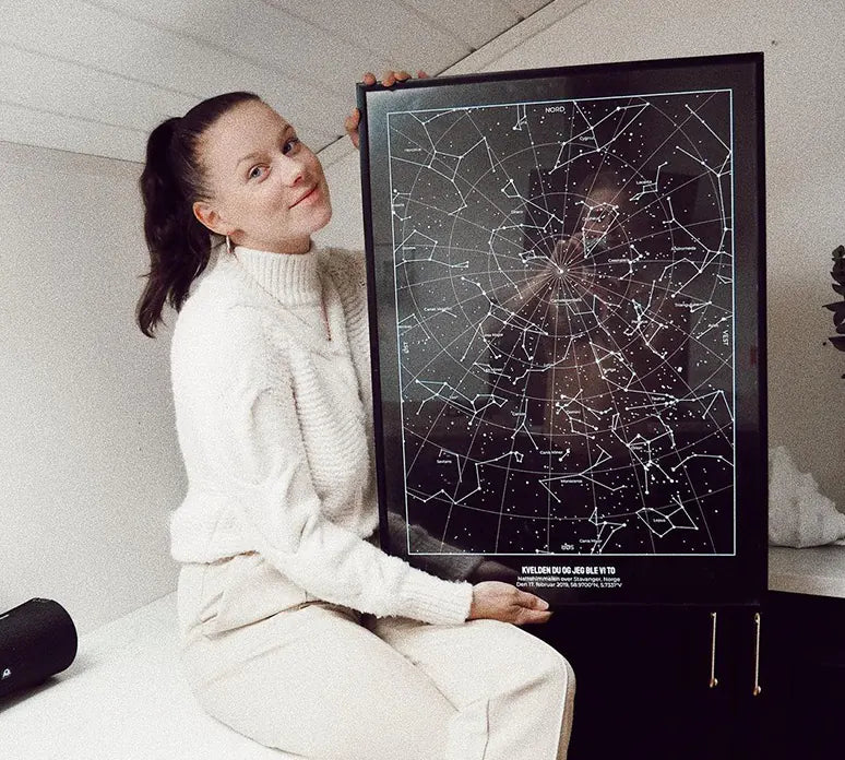 Girl holding Starmap with marking the moment she met her boyfriend