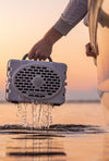 Speaker removed from water to show the waterproof feature