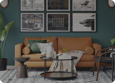 A modern living room showing a leather sofa with a coffee table and side chair, a white rug and decorative photos in the background, depicting some of the items that recently arrived and are available for sale in the Bay Area via Reperch.
