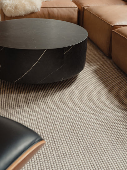 Photograph of a decorated living room with rug