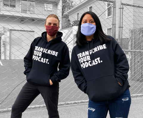 Hannah and Kisa rocking some comfy looking black pullover hooded sweatshirts with bold white "Transcribe Your Podcast" logo printed on the front chest.