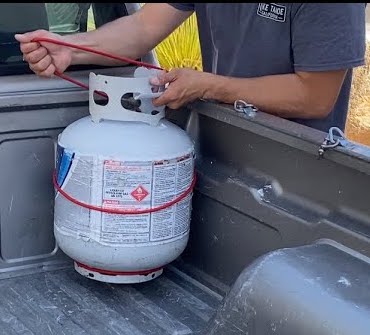 Right way to transport propane tank in a truck bed with bungee