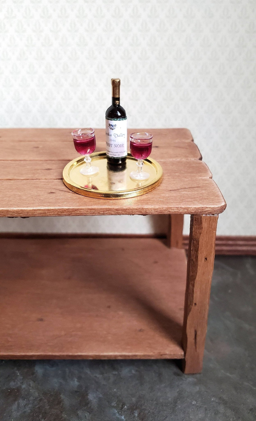 https://cdn.shopify.com/s/files/1/0001/9025/1052/products/dollhouse-miniature-red-wine-bottle-2-filled-wine-glasses-on-tray-112-scale-514046.jpg?v=1686416800&width=1080