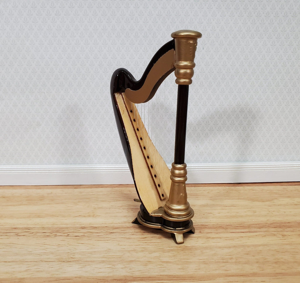 https://cdn.shopify.com/s/files/1/0001/9025/1052/products/miniature-harp-with-case-wood-2-316-112-scale-instrument-dollhouse-music-room-853152.jpg?v=1686419971&width=1000