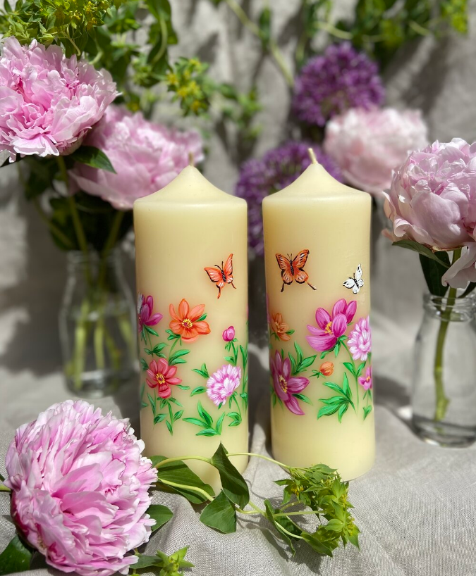 Hand painted candle featuring butterflies and flowers