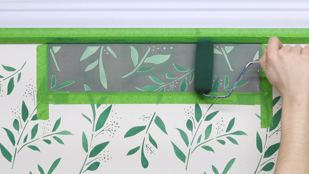 Finish stenciling the design by using the topper stencil along the top of your wall